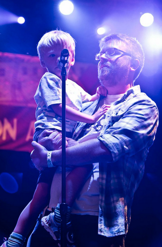 Some dude and his adorable kid, announcing The Dismemberment Plan.